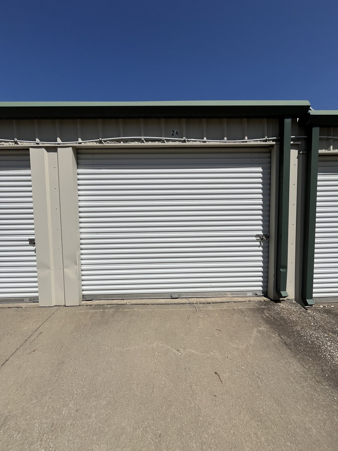 White roll-up storage unit door at Peculiar Storage